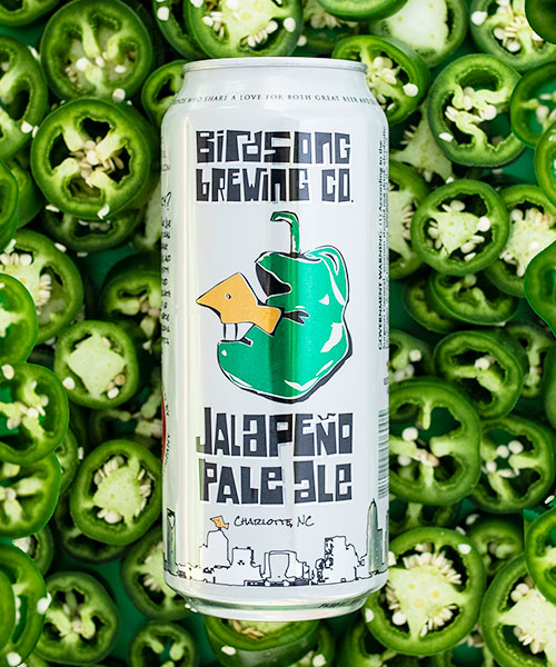 birdsong brewing co jalapeno pale ale with jalapenos in background