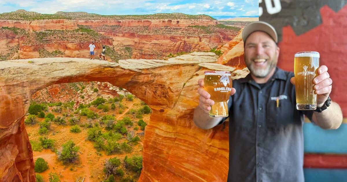 Brewer holding beers with red rock arch landscape in background