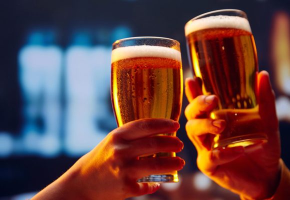 hands cheersing with beer