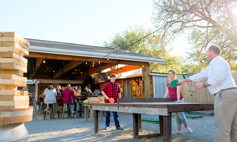 people playing ping pong at brewery