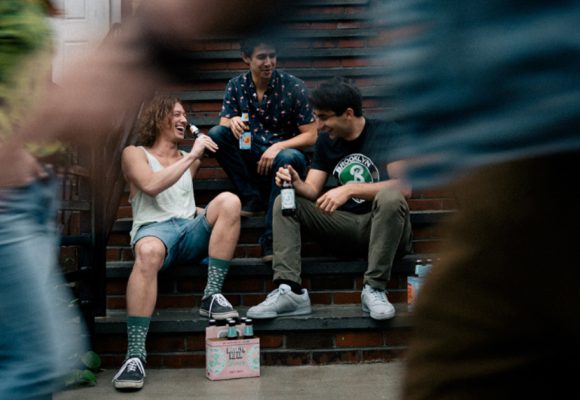 people sitting on porch drinking beer
