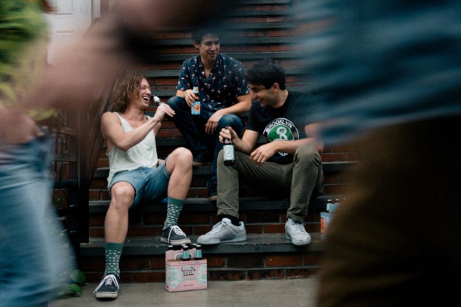 people sitting on porch drinking beer