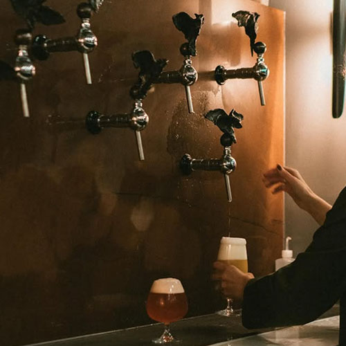 sky puppy tap wall with poured beers